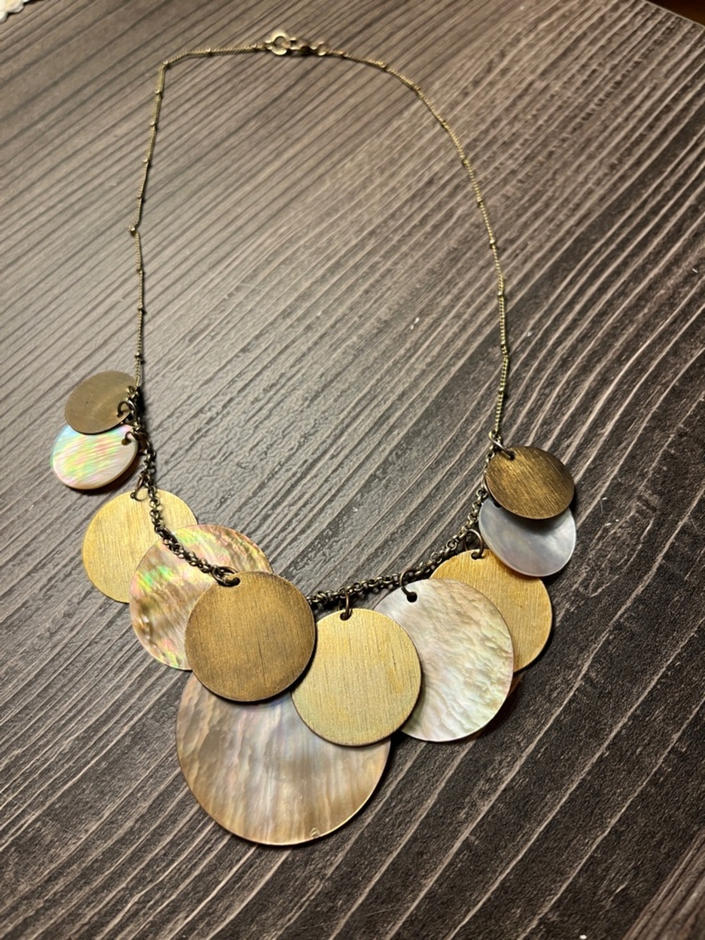 Unbranded abalone shell tiered disc necklace.
